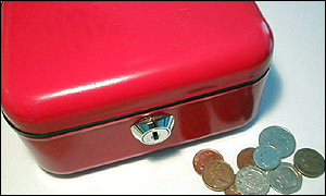 A red moneybox and some coins