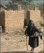 Woman in burnt down village 