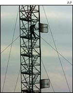 UN technician works on communications tower in Baghdad