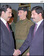 Saddam Hussein (left) with his younger son Qusay