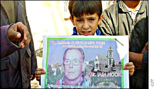 A Palestinian boy with a poster protesting Iain Hook's killing