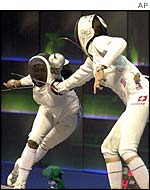 Two women fencing