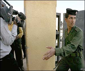 An Iraqi soldier prevents journalists from following the inspectors
