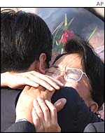 Japanese kidnap victim Fukie Hamamoto hugs a relative on her return to Japan, October 2002