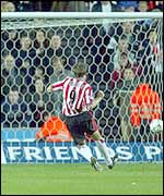 James Beattie slots home a penalty against Arsenal