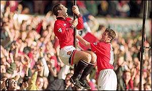 Eric Cantona celebrates his scoring return from a kung fu kick-induced supsension 