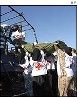 Red Cross workers carry bodies away from Paradise Hotel 