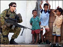 An Australian peacekeeper talks to East Timorese boys