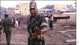 Kenyan soldier keeps people away from the site