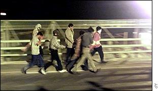 Asylum seekers making for the entrance to the Channel Tunnel