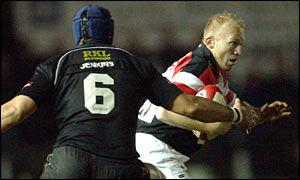 Neath back row Hywel Jenkins closes down Pontypridd fly-half Neil Jenkins