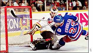 A player challenges the keeper in the goalmouth