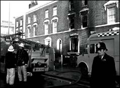 Emergency services outside the burnt-out house