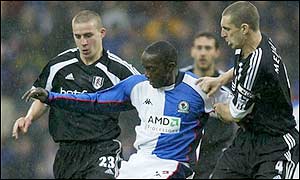 Dwight Yorke of Blackburn clashes with Andy Melville (left) and Sean Davis of Fulham 