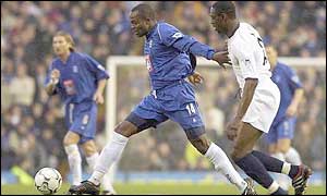 Birmimngham's Stern John and Spurs Ledley King chase down the ball
