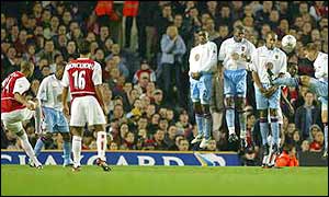 Thierry Henry's free-kick for Arsenal beats the Aston Villa wall 