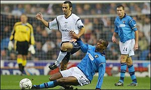 Manchester City's Sylvain Distain breaks up a Bolton attack led by Youri Djorkaeff