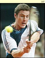Marat Safin hits a backhand against Sebastien Grosjean