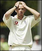 Richard Dawson holds his head in his hands