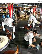 Crew members clean the Fascination's deck chairs 