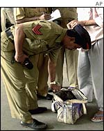 Indian police conduct a search at a Bombay railway station