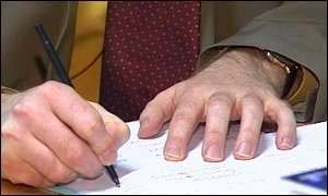 Hands writing a report