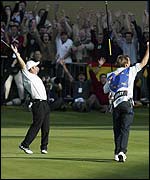 Paul McGinley celebrates as he sees his putt sink to win the Ryder Cup