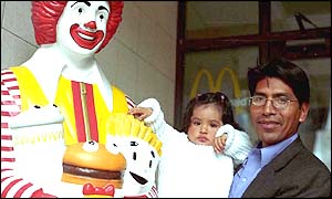 Child and adult with Ronald McDonald statue