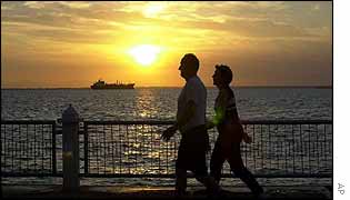 A couple pass the oil tanker Morichal at anchor on Lake Maracaibo 