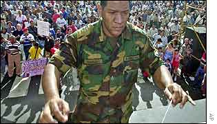 Army conductor leads salsa band at Caracas street market