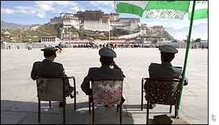Chinese police look over the Potala Palace in Lhasa, Tibet