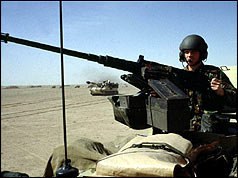Soldier from British Tank Division patrols the desert north of Kuwait City