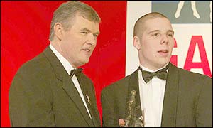 GAA president Sean McCague presents a 2002 All Star award to Donegal half-back Kevin Cassidy