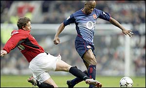 Ole Gunnar Solskjaer slides in to tackle Sylvain Wiltord 