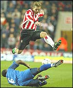 Anders Svensson hurdles Birmingham's Olivier Tebily