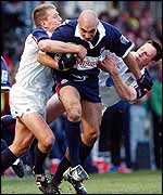 Brendon Daniel is tackled by Swansea's Shaun Payne and Mark Taylor