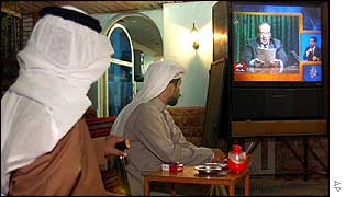 Kuwaiti men watch TV broadcast of Saddam statement