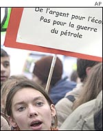 A student holding a placard reading 