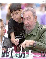 Cuban President Fidel Castro (left) ponders his move
