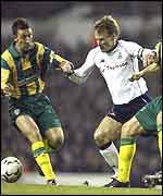 Spurs captain Tedy Sheringham battles away