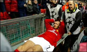 David Beckham being taken off the pitch, PA