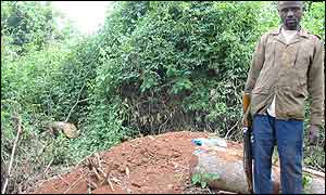 A rebel soldier standing near the grave