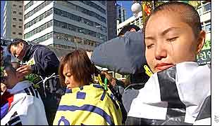 Protesters have their hair cut during an anti-US rally at a church in Seoul, Tuesday, 10 Dec. 2002