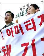 Protesters shout a slogan during an anti-US rally to oppose Mr Armitage's visit near the US embassy in Seoul