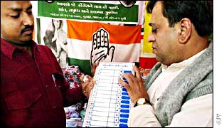 Shopkeeper displays an electronic voting machine in Ahmedabad, Gujarat