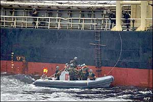 A Spanish boat approaches to board the unflagged ship So San in the Arabian Sea