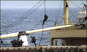 Marines descend by rope onto the So San's deck