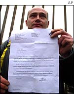A Fiat worker shows his letter of temporary dismissal 