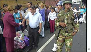 Venezuelans queue outside a supermarket