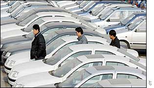 Chinese men in a car lot